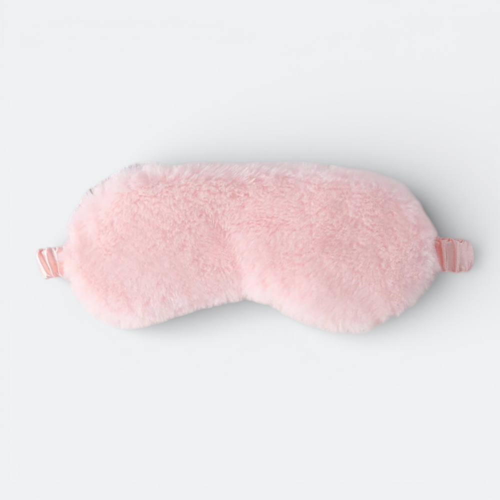 AïtaVia pink plush sleep mask with satin elastic strap, ideal for travel and blocking light for deep sleep.