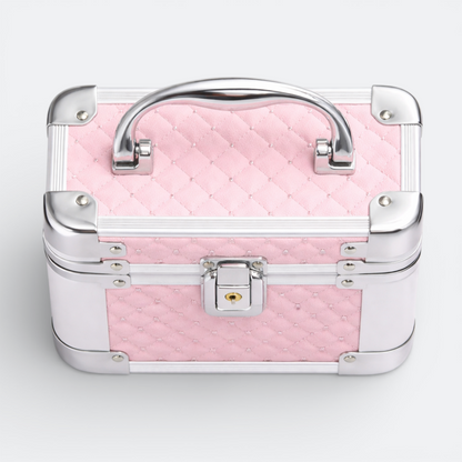 AïtaVia pink quilted cosmetic travel jewelry box with silver trim and handle. Features a lock closure.
