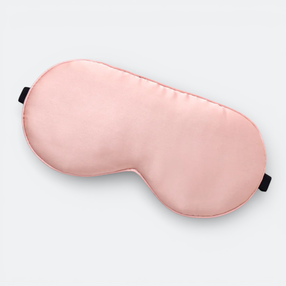 AïtaVia pink silk sleep mask with adjustable black strap for travel and comfortable sleep.