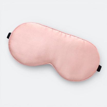 AïtaVia pink silk sleep mask with adjustable black strap for travel and comfortable sleep.