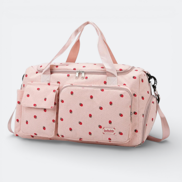 AïtaVia pink corduroy duffel bag with a strawberry print, featuring multiple pockets and adjustable strap.