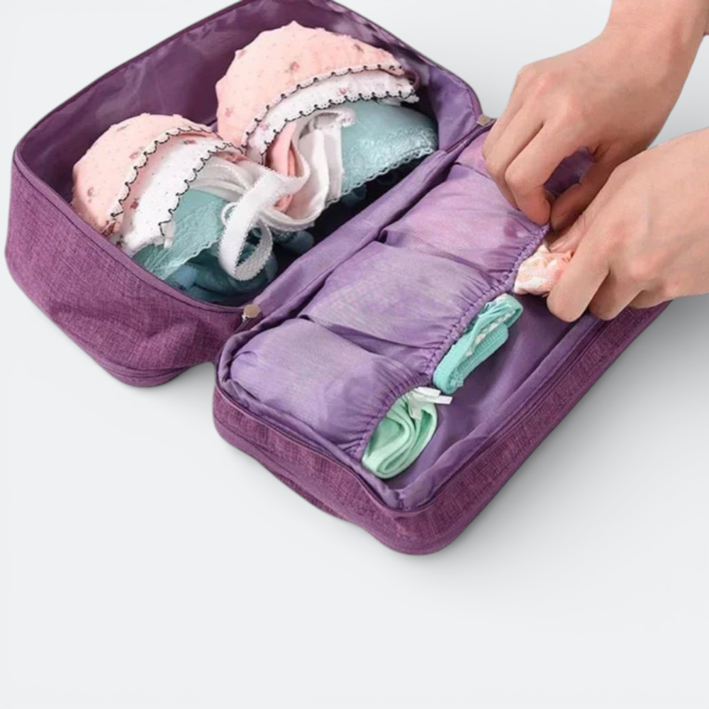 AïtaVia purple travel underwear organizer bag with multiple compartments holding bras and socks.