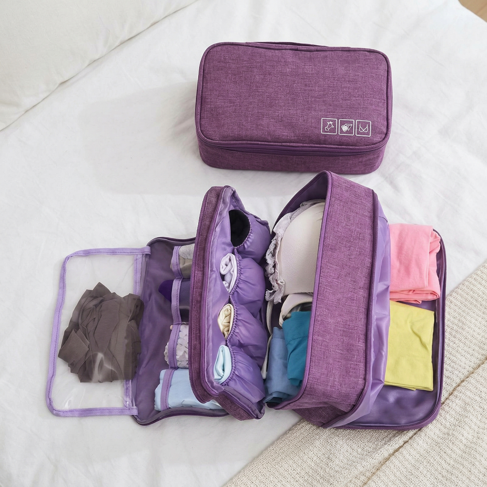 AïtaVia purple travel underwear organizer bag, open to show compartments for bras, socks, and underwear.