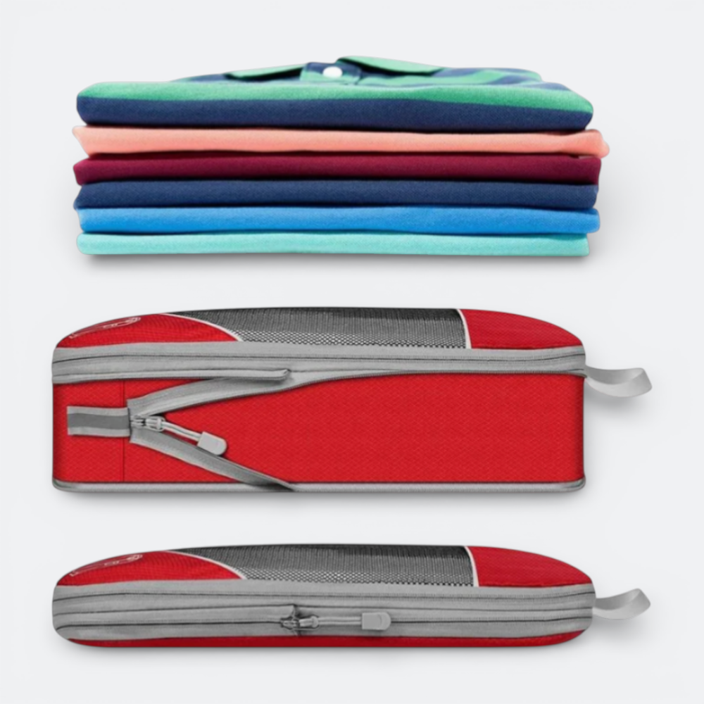 AïtaVia red compressible packing cube with mesh top and grey trim, shown empty and compressed, next to a stack of folded striped polo shirts.