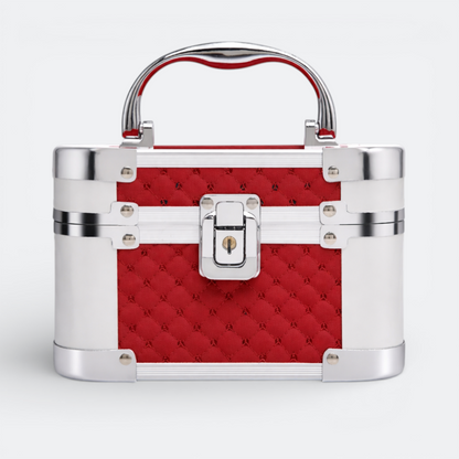 AïtaVia red quilted cosmetic travel jewelry box with silver trim and handle. Features a central clasp and lock.