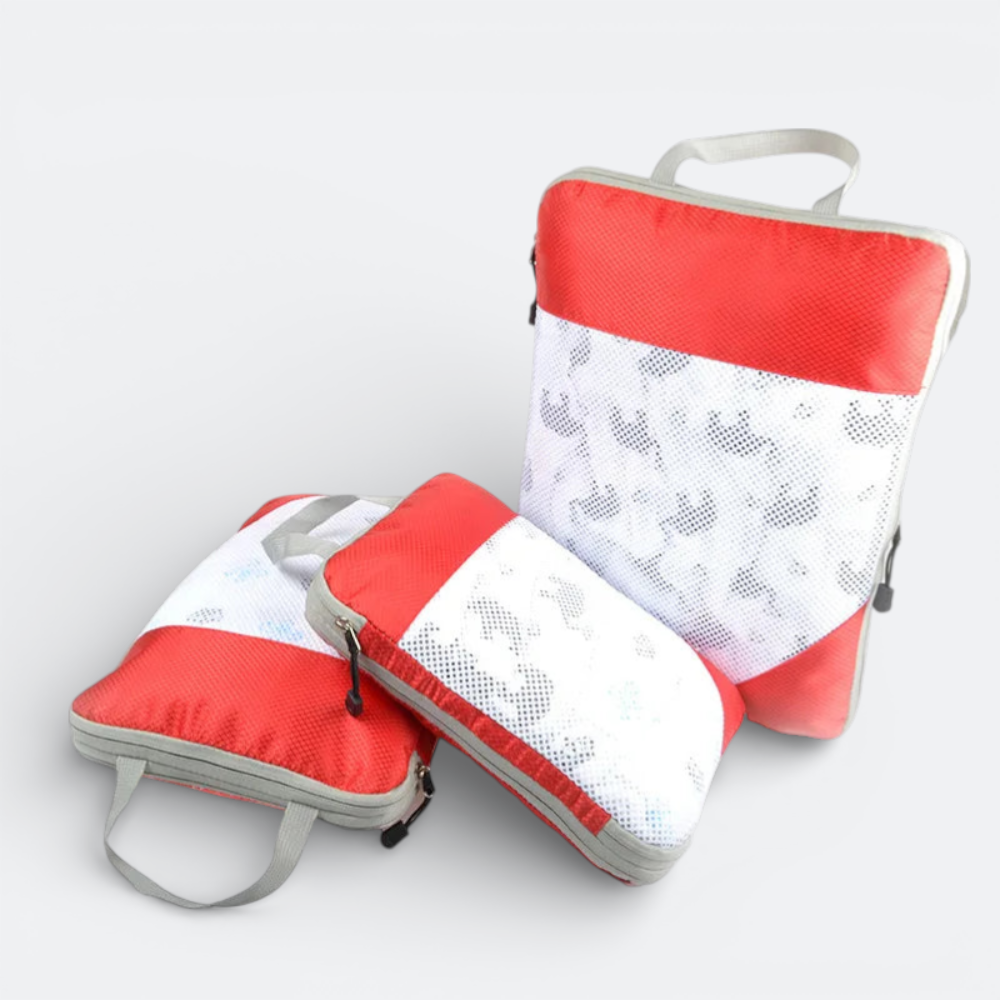 AïtaVia red and white mesh packing cubes with grey trim and handles, ideal for cabin luggage organization.