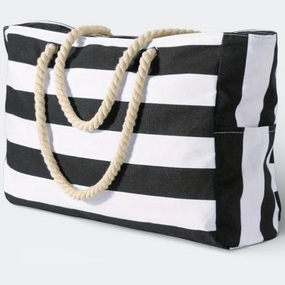 AïtaVia black and white striped canvas beach tote bag with rope handles and side pockets.
