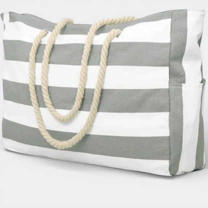 AïtaVia large grey and white striped canvas beach tote bag with rope handles and side pockets.