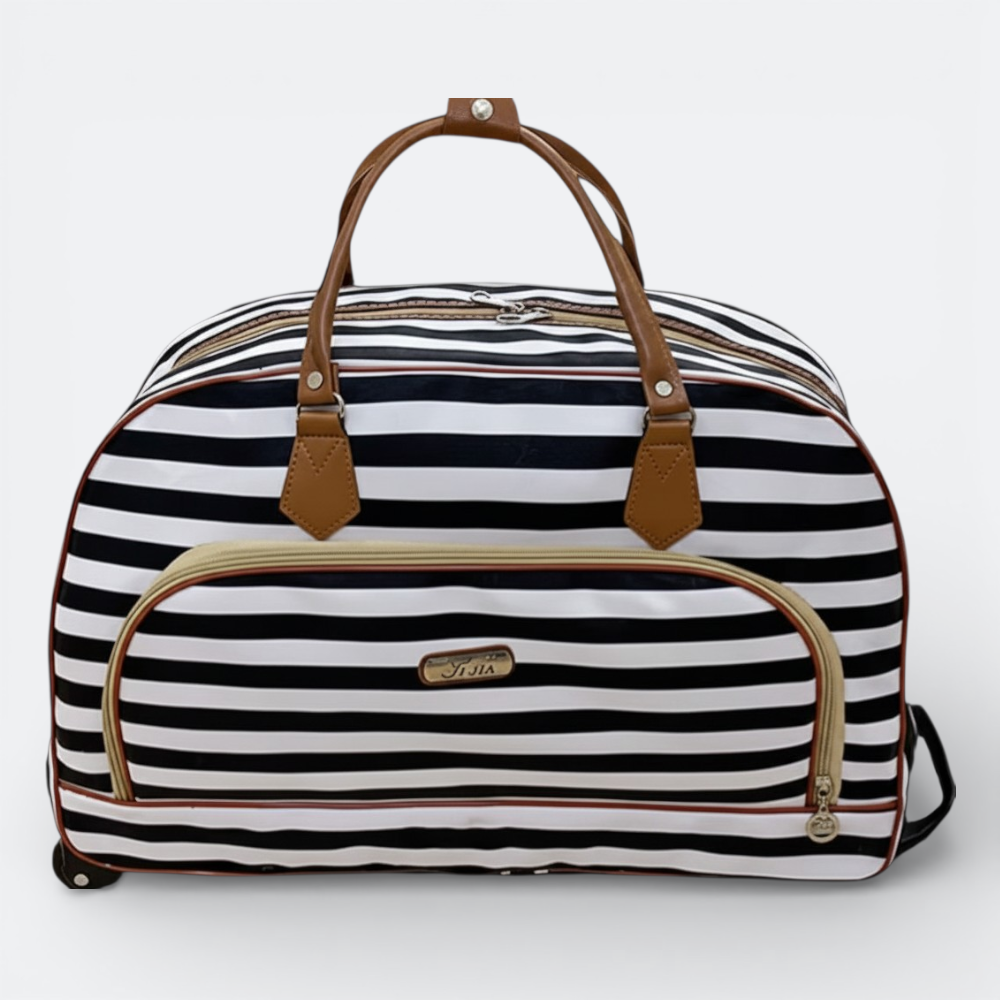 AïtaVia black and white striped travel duffel bag with brown leather handles and trim. Features a front zip pocket and wheels.