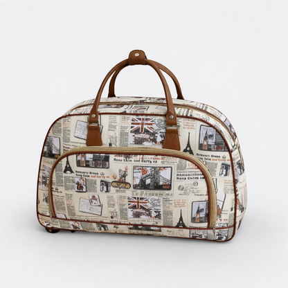 AïtaVia vintage travel duffel bag with newspaper print, Union Jack, Eiffel Tower, and London landmarks. Tan leather handles and trim.