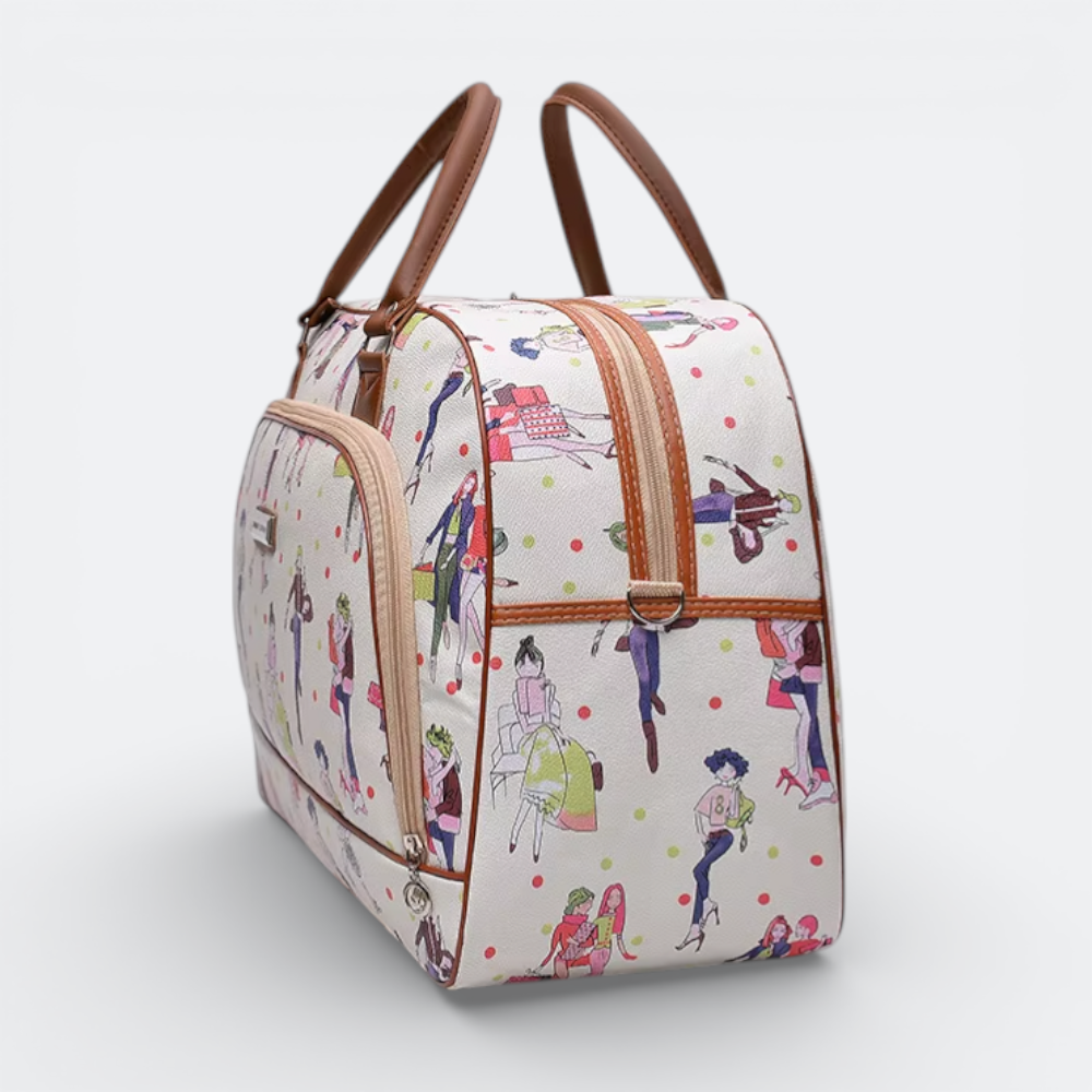 AïtaVia white travel duffel bag with a playful print of fashion illustrations and polka dots. Features brown leather handles and trim.