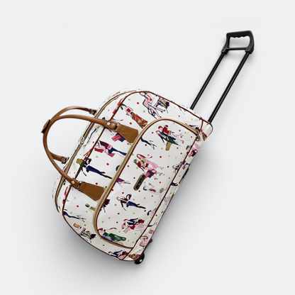 AïtaVia white travel duffel bag with a colourful fashion illustration print and brown leather accents. Features wheels and a retractable handle.