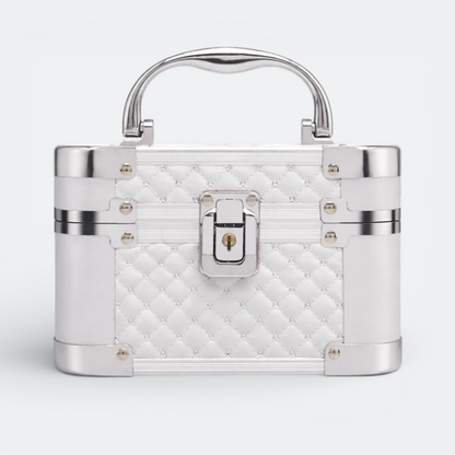 AïtaVia white quilted cosmetic travel jewelry box with silver trim and handle, featuring a lock closure.