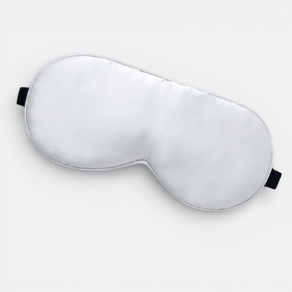 AïtaVia white silk sleep mask with black elastic straps for travel and comfortable sleep.