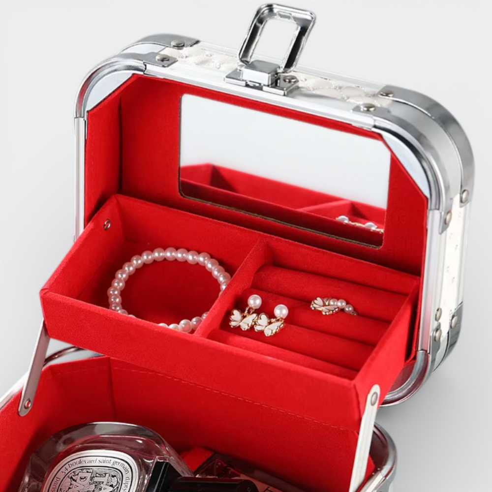 AïtaVia white travel jewelry and cosmetic case with red velvet lining, mirror, and compartments for rings, earrings, and bracelets.