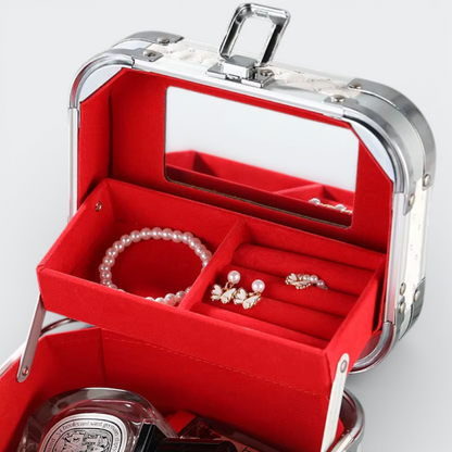 AïtaVia white travel jewelry and cosmetic case with red velvet lining, mirror, and compartments for rings, earrings, and bracelets.