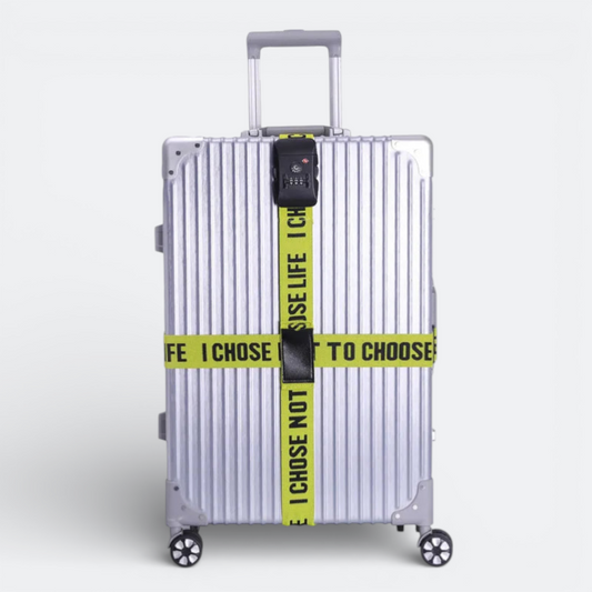 AïtaVia silver suitcase with a bright yellow luggage strap featuring black text and a TSA-approved combination lock.