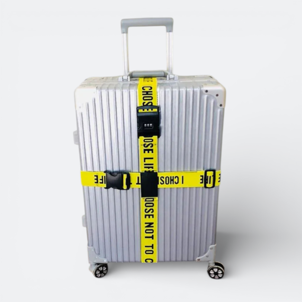 AïtaVia yellow luggage strap with black code lock and buckle, secures silver suitcase.
